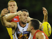 Whistled past the ear: Hawks Johnathan Ceglar attempts to mark as the Suns spoil