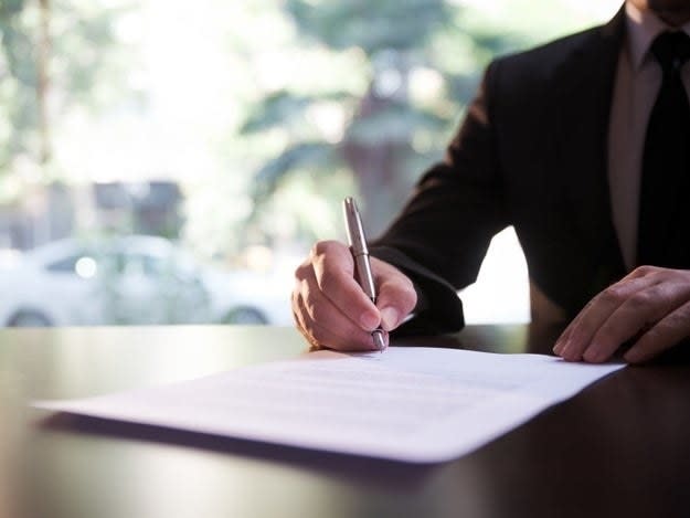 A person signs a document