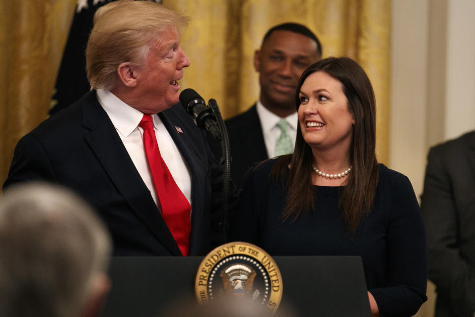 President Donald Trump welcomes White House press secretary Sarah Sanders to the stage as he pauses from speaking about second chance hiring to publicly thank the outgoing press secretary in the East Room of the White House, Thursday June 13, 2019, in Washington. (AP Photo/Jacquelyn Martin)