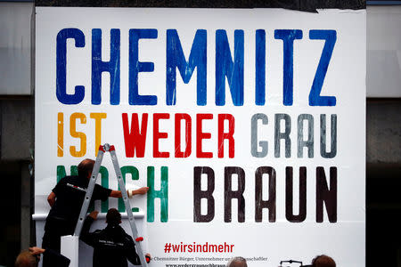 Locals attach a banner reading "Chemnitz is neither grey nor brown" on the Karl Marx monument in Chemnitz, Germany September 1, 2018. REUTERS/Hannibal Hanschke