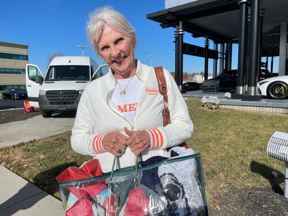 Jan Benton of Bearden brings dog food and a beautiful pet blanket. She said she lost her little dog in April and came to get some puppy kisses at the inaugural Stuff the Sprinter for Homeless Pets event held at Mercedes-Benz of Knoxville on 10131 Parkside Drive on Nov. 11, 2023.