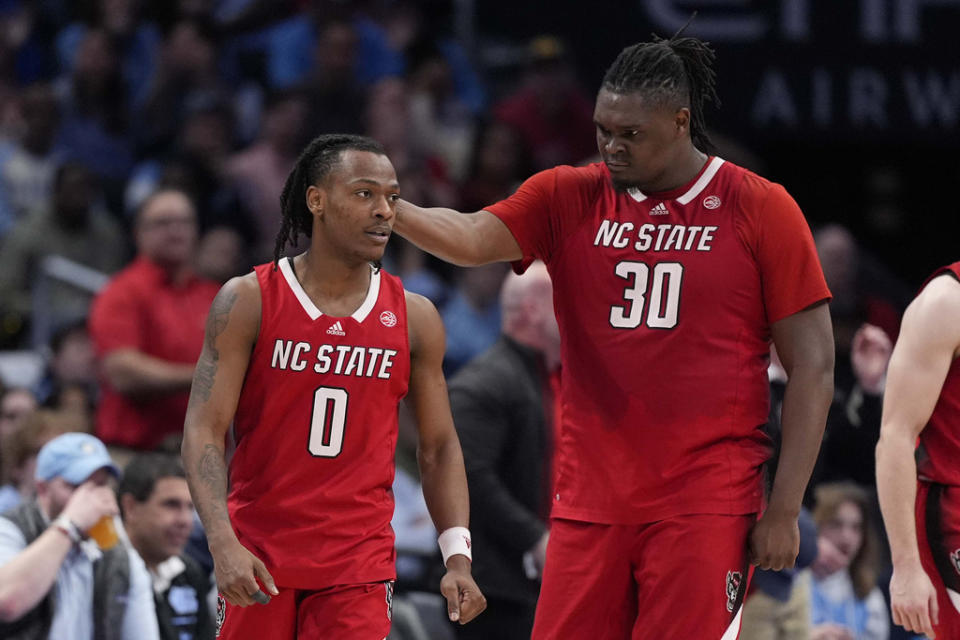 North Carolina State guard DJ Horne (0) and North Carolina State forward DJ Burns Jr. (30) celebrating after scoring against North Carolina during the second half of an NCAA college basketball game in the championship of the Atlantic Coast Conference tournament, Saturday, March 16, 2024, in Washington. (AP Photo/Alex Brandon)