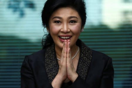 Ousted former Thai prime minister Yingluck Shinawatra greets supporters as she arrives at the Supreme Court in Bangkok, Thailand, August 1, 2017. REUTERS/Athit Perawongmetha