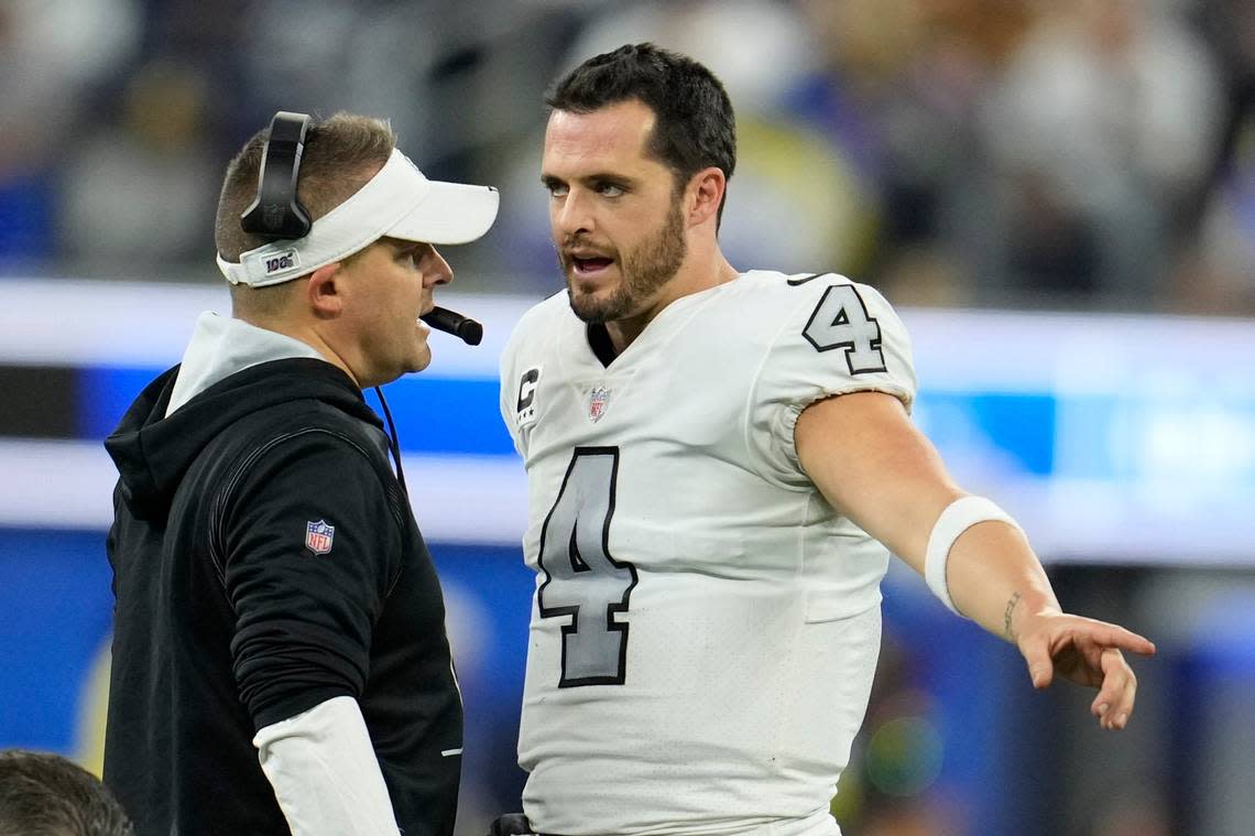 Las Vegas Raiders coach Josh McDaniels talks with quarterback Derek Carr during the second half of an NFL game against the Los Angeles Rams, Thursday, Dec. 8, 2022, in Inglewood, Calif.