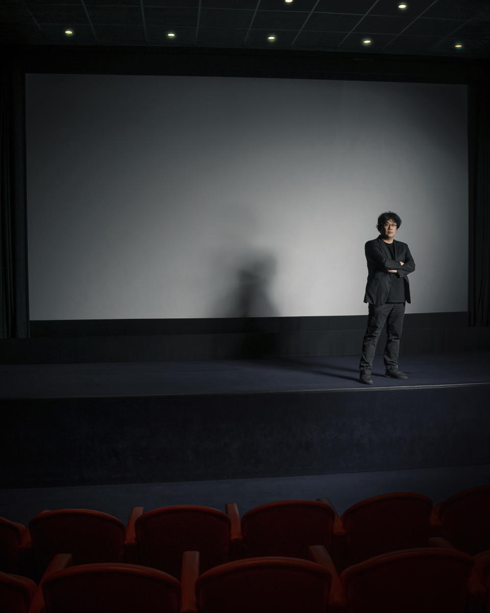 This Oct. 8, 2019 photo shows filmmaker Bong Joon-Ho posing for a portrait at the Whitby Hotel screening room in New York to promote his film "Parasite." The film will open in theaters Friday having already amassed $70.9 million in Bong's native South Korea. In May, "Parasite" won the Palme d’Or at the Cannes Film Festival, a first for a Korean film. (Photo by Christopher Smith/Invision/AP)