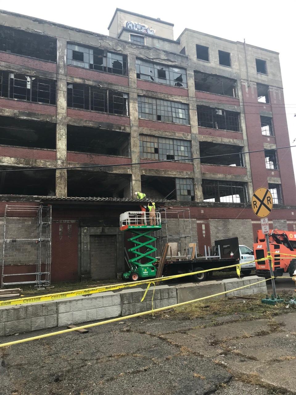 Employees of WR Restoration of Twinsburg worked Wednesday to maintain overhead protection before removing the doorway of the former Westinghouse building on East Fifth Street. The doorway will become a monument to Mansfield manufacturing at the site in the future.