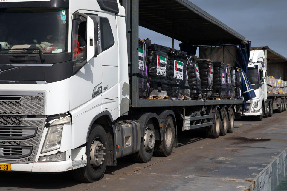 This image provided by the U.S. Army shows trucks loaded with humanitarian aid from the United Arab Emirates and the United States Agency for International Development cross the Trident Pier before arriving on the beach on the Gaza Strip Friday, May 17, 2024. Trucks carrying badly needed aid for the Gaza Strip rolled across a newly built U.S. pier and into the besieged enclave for the first time Friday as Israeli restrictions on border crossings and heavy fighting hindered the delivery of food and other supplies.(U.S. Navy photo by Mass Communication Specialist 1st Class Kelby Sanders)