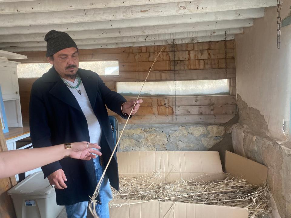 Ira Vandever works with the hemp he received from Minnesota to process.