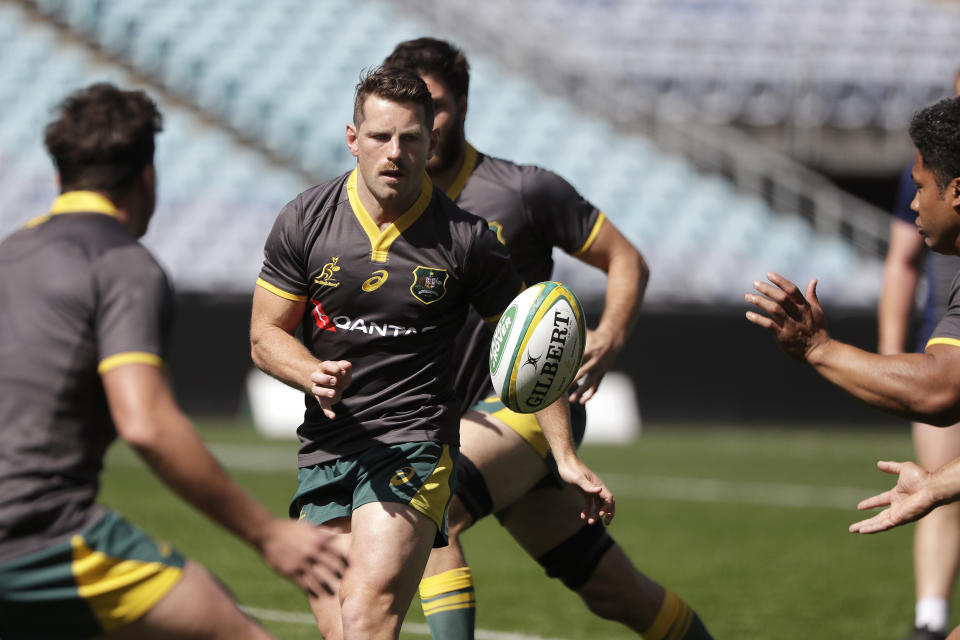 FILE - Bernard Foley, center, passes the ball as the Australian rugby union team trains ahead of their test match against Samoa in Sydney, Australia on Sept. 6, 2019. Bernard Foley has been drafted into Australia’s squad for the first time since the 2019 World Cup, recalled at the expense of James O’Connor for two Rugby Championship tests against South Africa. (AP Photo/Rick Rycroft, File)