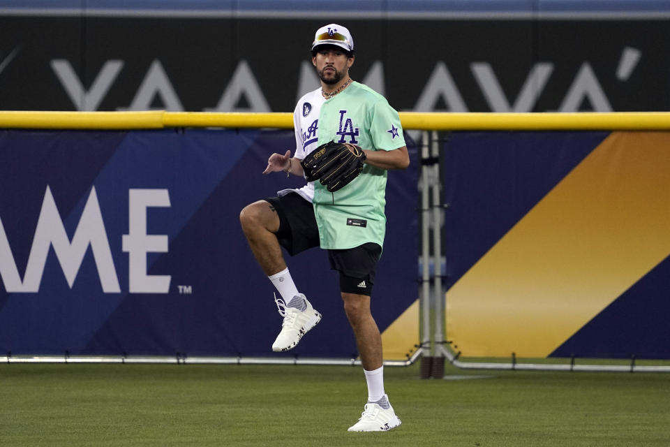 Rapper and singer Bad Bunny runs in the outfield during the MLB All Star Celebrity Softball game, Saturday, July 16, 2022, in Los Angeles. (AP Photo/Mark J. Terrill)