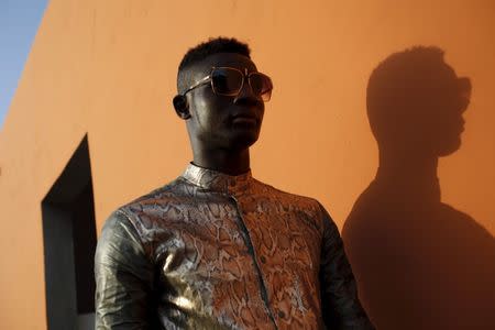 Model Mamadou Racine poses for a picture in a bazin suit made by designer Barros Coulibaly in Bamako, Mali, October 21, 2015. REUTERS/Joe Penney