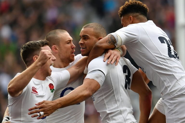 England's Jonathan Joseph (2R) celebrates with teammates after scoring his team's first try during their Six Nations international rugby union match against Scotland on March 11, 2017