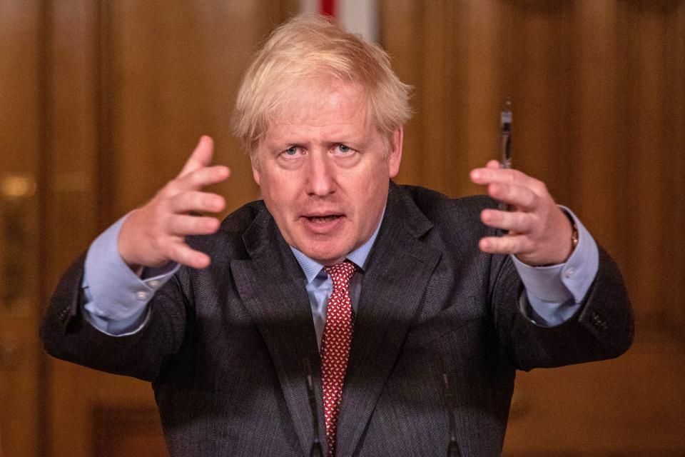 Britain's Prime Minister Boris Johnson gestures at a remote press conference to update the nation on the covid-19 pandemic, inside 10 Downing Street in central London on September 30, 2020, the 100th coronavirus briefing since the pandemic hit the UK. - New restrictions are being introduced as infection rates rise again, with some 16 million people now subject to some kind of localised rules across the UK, including bans on meeting other families. (Photo by Jack Hill / POOL / AFP) (Photo by JACK HILL/POOL/AFP via Getty Images)