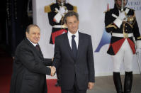 FILE - In this Friday, May 27, 2011, file photo, French President Nicolas Sarkozy, right, welcomes Algerian President Abdelaziz Bouteflika prior to a round table meeting at the G8 summit in Deauville, France. Former Algerian President Bouteflika, who fought for independence from France in the 1950s and 1960s and was ousted amid pro-democracy protests in 2019 after 20 years in power, has died at age 84, state television announced Friday, Sept. 17, 2021. (Damien Meyer/Pool Photo via AP)