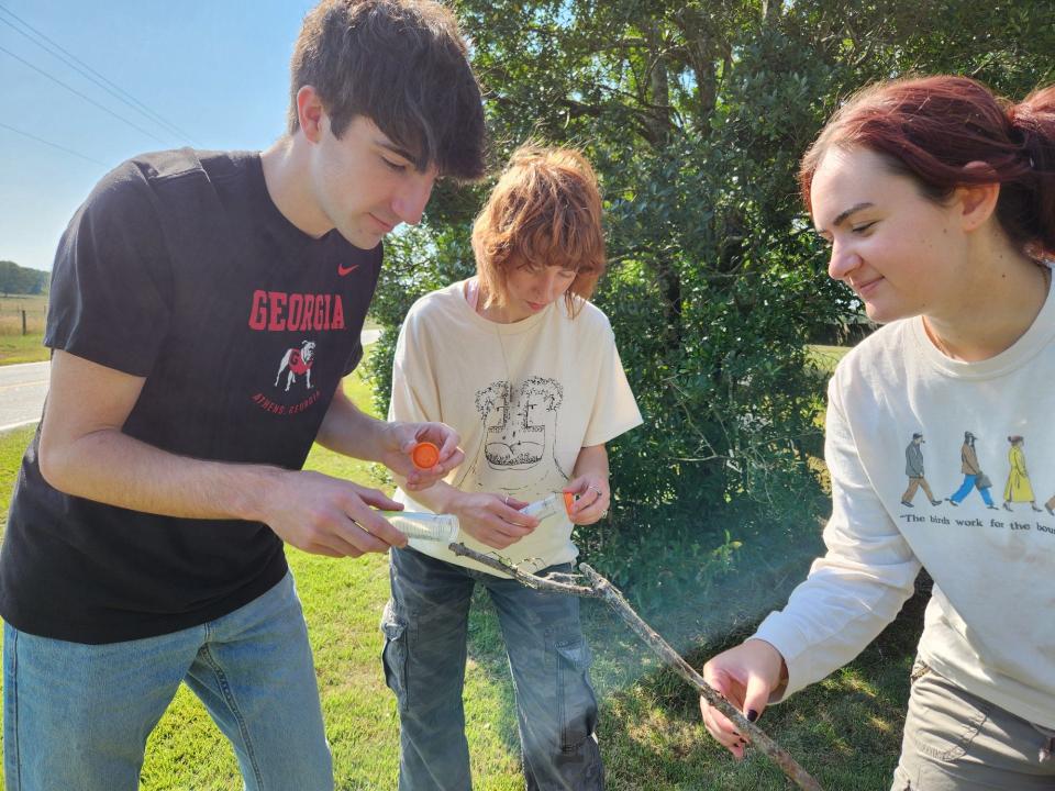 UGA students Kade Stewart, Alexa Schultz and Caitlin Phelan collect Joro spiders for their study project.