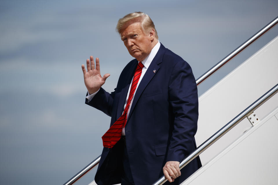 In this Sept. 26, 2019 photo, President Donald Trump waves to reporters as he steps off Air Force One after arriving at Andrews Air Force Base, in Andrews Air Force Base, Md. A whistle blew, an impeachment inquiry swung into motion and the president at the center of it all rose defiantly to his own defense, not always in command of the facts. (AP Photo/Evan Vucci)