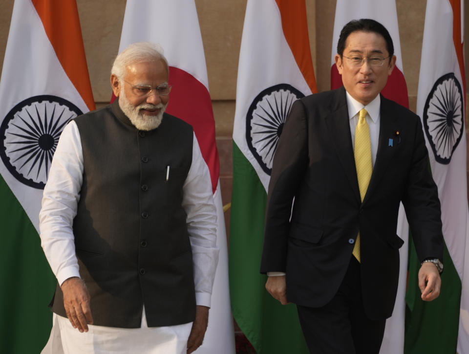 Indian Prime Minister Narendra Modi walks with his Japanese counterpart Fumio Kishida in New Delhi, Saturday, March 19, 2022. Kishida is meeting with Modi to strengthen their partnership in the Indo-Pacific and beyond in view of China’s growing footprint in the region, an Indian official said Thursday. (AP Photo/Manish Swarup)