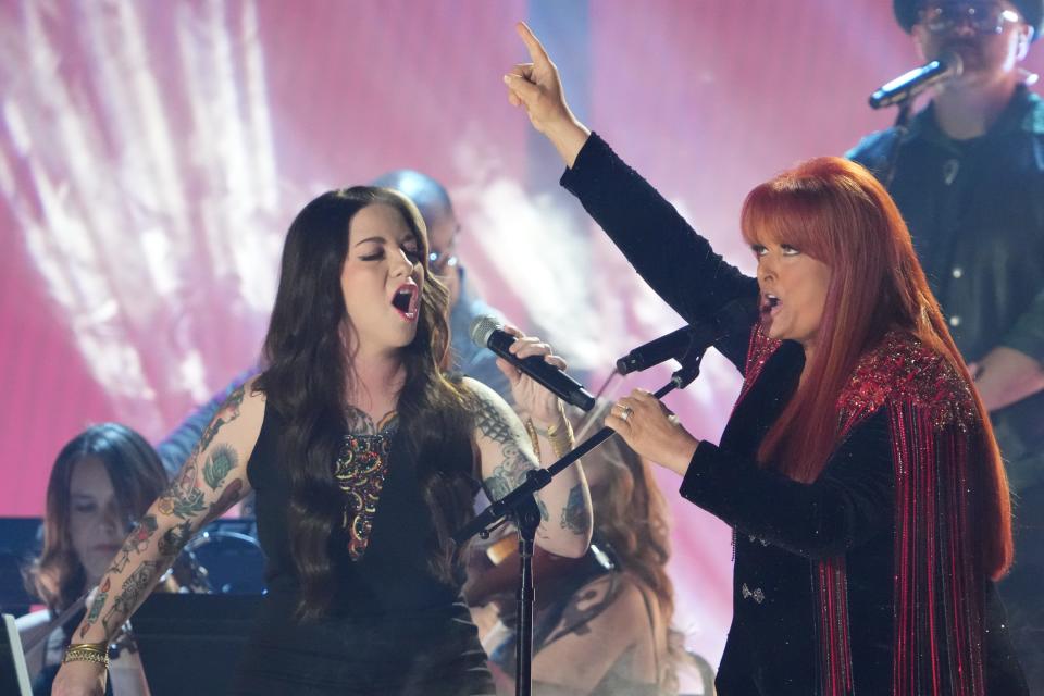 Ashley McBryde (left) joins Wynonna Judd at the CMT Awards in April. McBryde is one of many country artists who are interviewed for a new documentary about Judd's life since the suicide last year of her mother and singing partner, Naomi Judd.