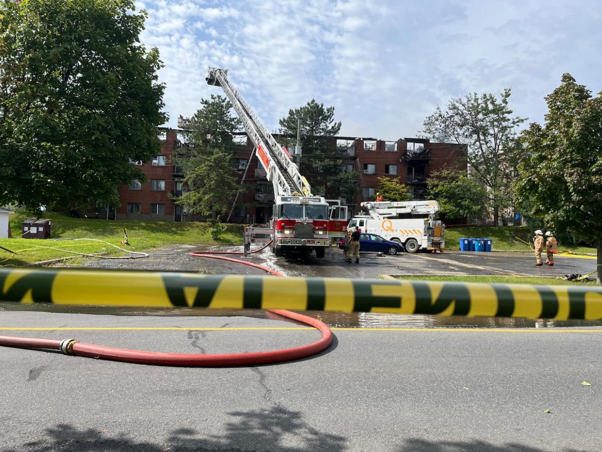 Firefighters were called to a social housing complex on St-Hubert Street in Châteauguay, Que., on Thursday. (Paula Dayan-Perez/CBC - image credit)