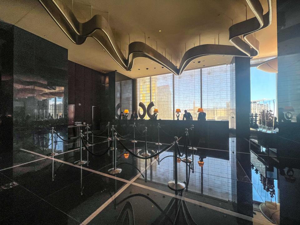 A hotel lobby with lots of black marble.