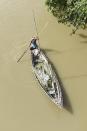 Villager uses a boat to move across a flooded area in a flood effected village in Morigaon district of Assam in India on Friday, 17 July 2020. (Photo by David Talukdar/NurPhoto via Getty Images)