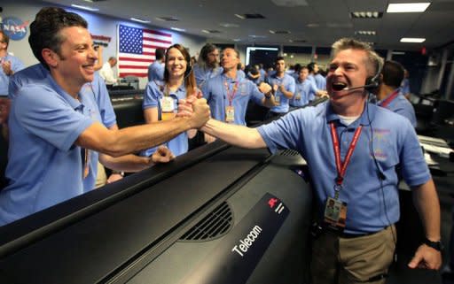 MSL Flight director Keith Comeaux (R) celebrates with Martin Greco after a successful landing for the Curiosity rover