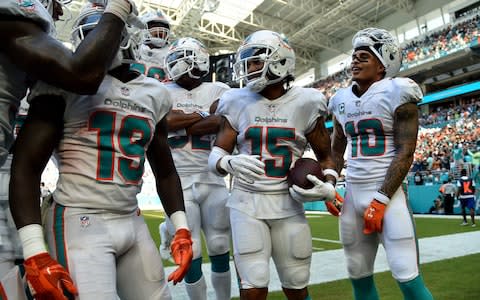 Miami Dolphins wide receiver Albert Wilson (15) celebrates with teammates after scoring a touchdown during the second half against the Oakland Raiders - Credit: (Steve Mitchell/USA Today)