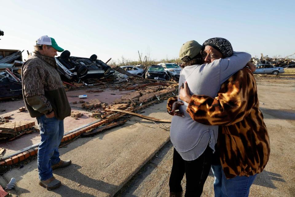 Tracy Hardin, center, who with her husband Tim, left, own Chuck’s Dairy Bar, consoles a neighbor in Rolling Fork, Mississippi (Copyright 2023 The Associated Press. All rights reserved)