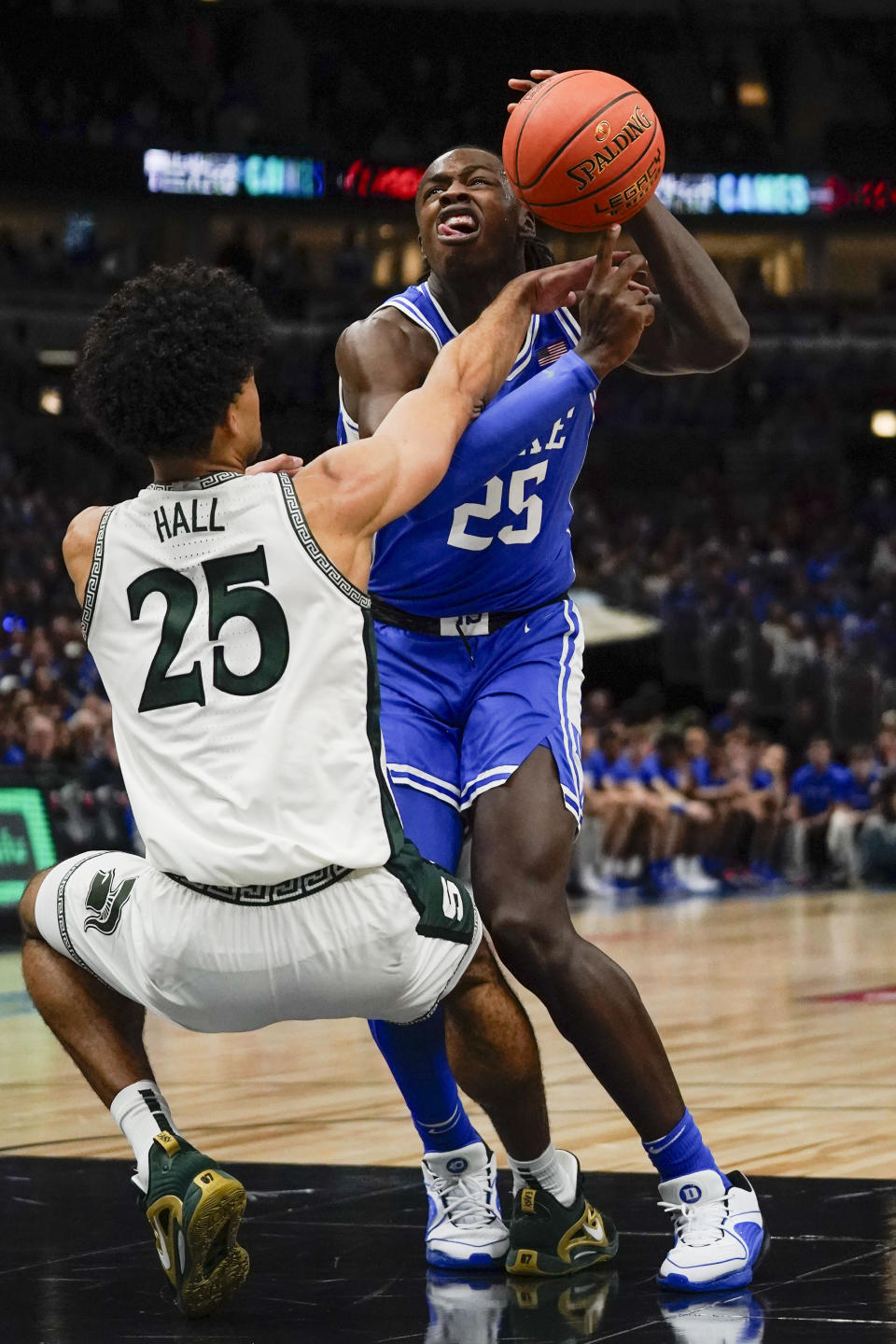 Duke forward Mark Mitchell, right, gets fouled by Michigan State forward Malik Hall during the first half of an NCAA college basketball game Tuesday, Nov. 14, 2023, in Chicago. (AP Photo Erin Hooley)