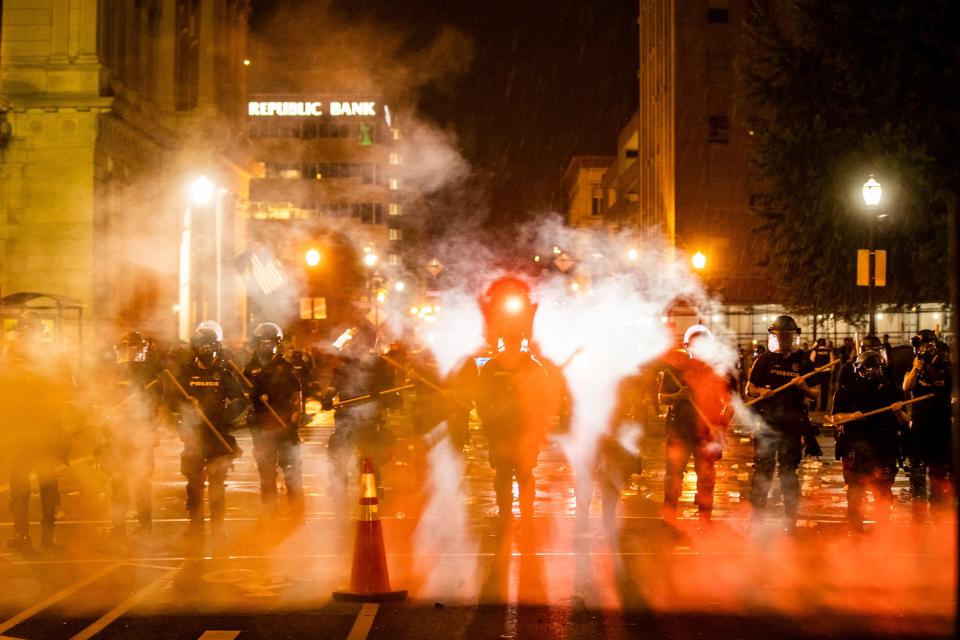 Louisville police move through a cloud of tear gas May 29, 2020, as the deaths of Louisville's Breonna Taylor and Minneapolis' George Floyd at the hands of police spurred protests.