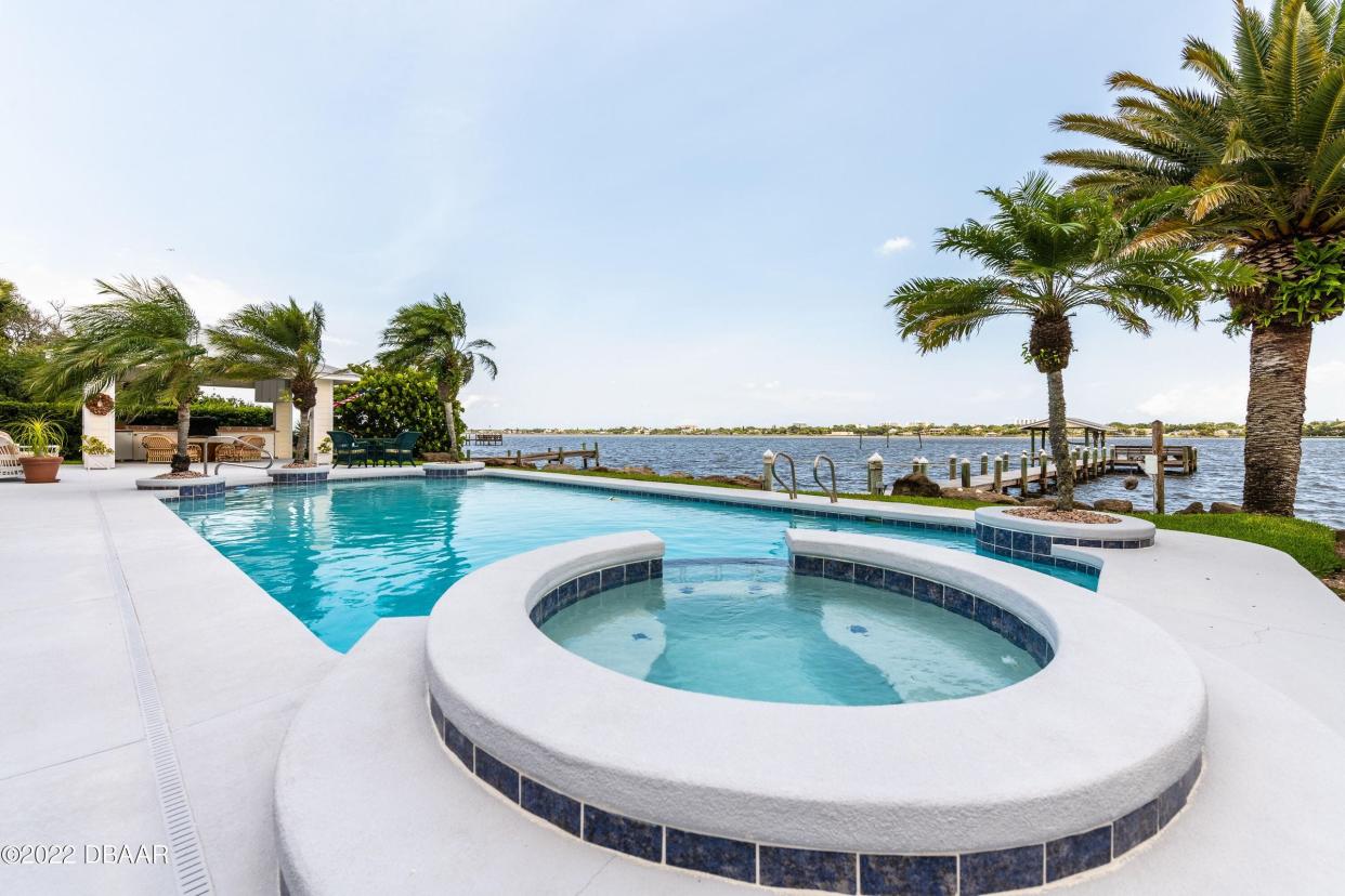 Enjoy breezes and forever views from the pool and spa, surrounded by a riverfront patio.