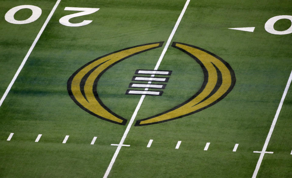 FILE - The College Football Playoff logo is shown on the field at AT&T Stadium before the Rose Bowl NCAA college football game between Notre Dame and Alabama in Arlington, Texas, Jan. 1, 2021. ESPN and the College Football Playoff have agreed to a six-year deal worth $1.3 billion annually that allows the network to keep exclusive rights to the 12-team playoff through the 2031 season, two people with knowledge of the agreement told The Associated Press, Tuesday, Feb. 13, 2024. (AP Photo/Roger Steinman, File)