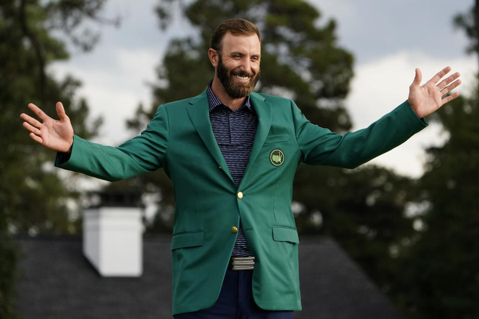 FILE - Masters golf champion Dustin Johnson shows off his green jacket after his victory in Augusta, Ga., in this Sunday, Nov. 15, 2020, file photo. Johnson was sure to send Phil Mickelson a text about his whereabouts next year the night of the champions dinner. (AP Photo/Matt Slocum, File)