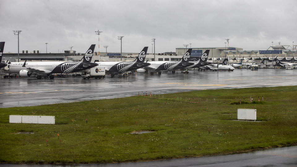 Planes wait on the tarmac at Auckland Airport after flights were cancelled and passengers stranded as a cyclone hit the northern parts of New Zealand, Sunday, Feb. 12, 2023. New Zealand's national carrier has canceled dozens of flights as Aucklanders brace for a deluge from Cyclone Gabrielle, two weeks after a record-breaking storm swamped the nation's largest city and killed several people. (George Heard/NZ Herald via AP)