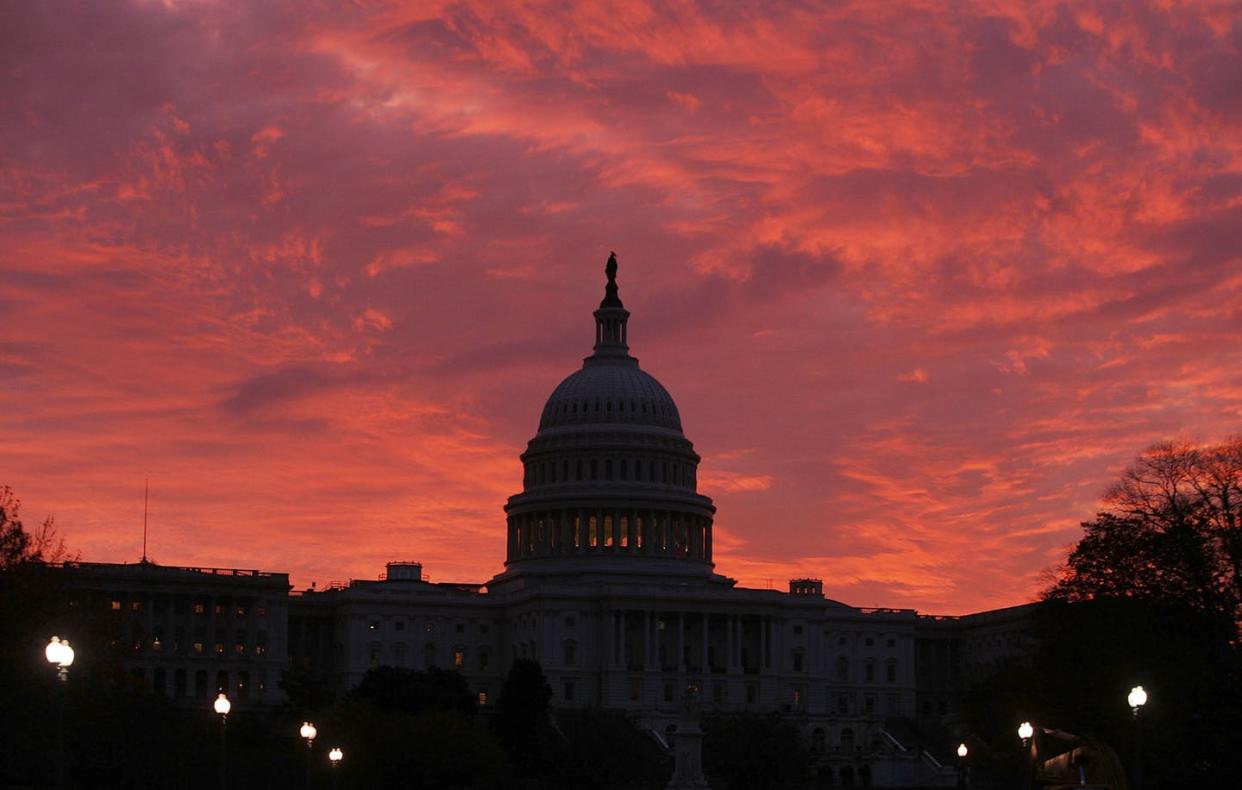 <span class="caption">Red sky at night, federal workers take fright? </span> <span class="attribution"><a class="link " href="https://www.gettyimages.com/detail/news-photo/the-early-morning-sun-lights-up-the-sky-behind-the-u-s-news-photo/72581249?adppopup=true" rel="nofollow noopener" target="_blank" data-ylk="slk:Mark Wilson/Getty Images;elm:context_link;itc:0;sec:content-canvas">Mark Wilson/Getty Images</a></span>