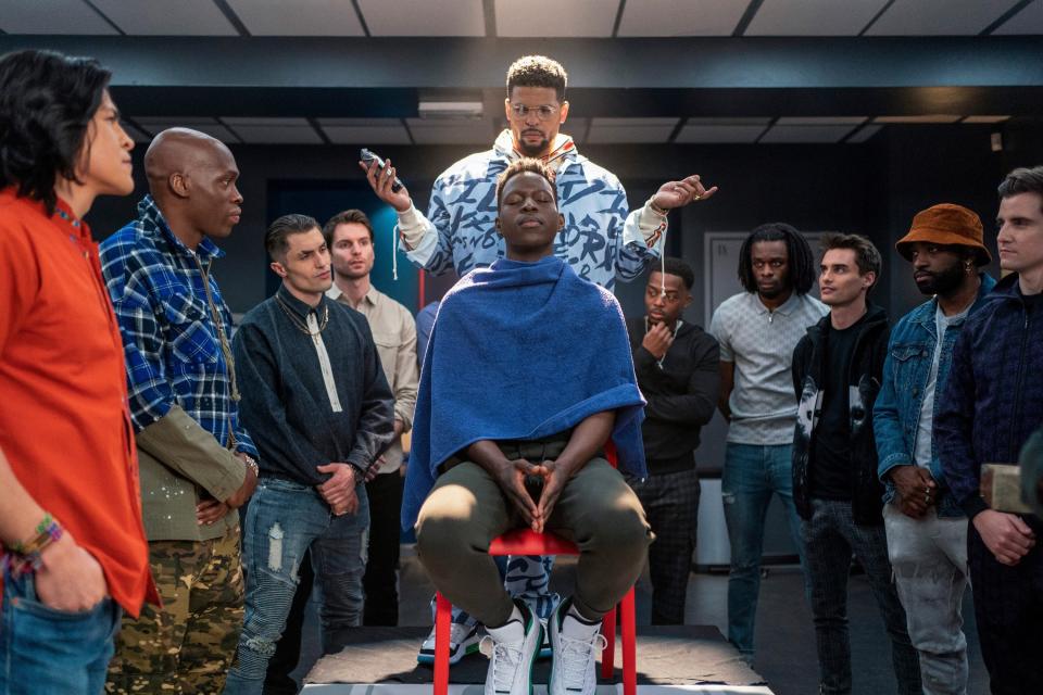 player getting his head shaved in front of his teammates