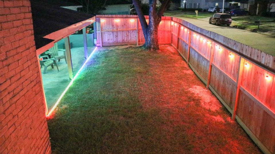 An overhead shot of a backyard decorated with Govee's smart outdoor string lights and outdoor neon rope lights