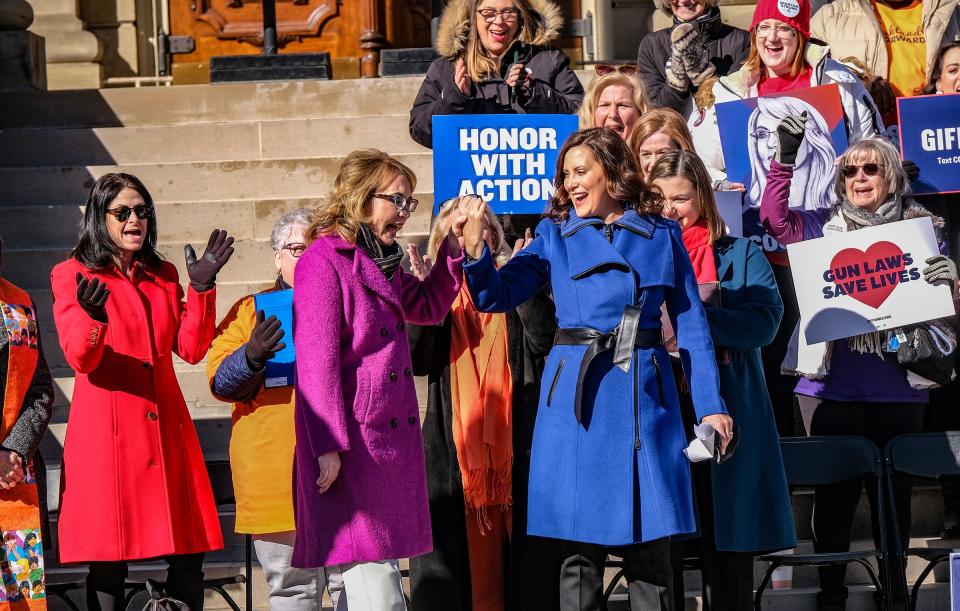 Michigan Governor Gretchen Whitmer, right, assists former Congresswoman Gabrielle Giffords to the stage set up on the steps of the Capitol as part of a gun violence prevention rally Wednesday, Mar. 15, 2023. Giffords and others spoke to the crowd about adopting common sense gun legislation. 