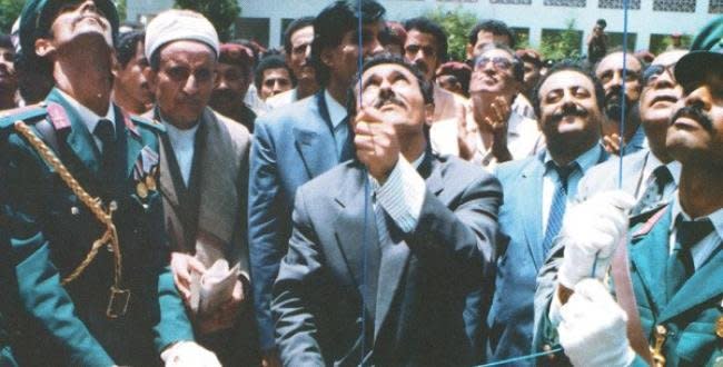 Yemeni President Ali Saleh raises the Yemeni flag on May 22, 1990, at a ceremony marking the unification of North Yemen and South Yemen. File Photo courtesy of Wikimedia Commons