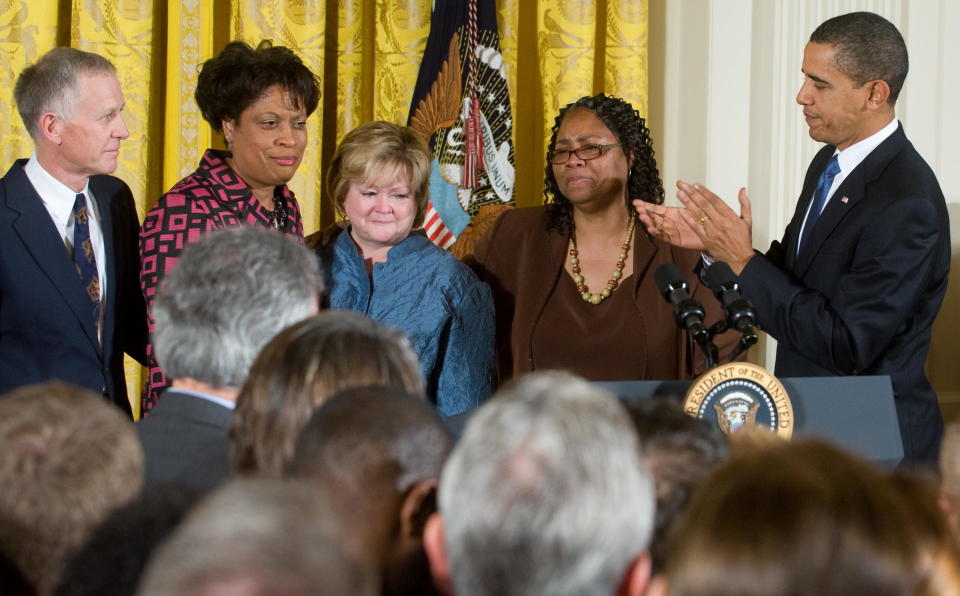 Then-president Barack Obama applauds the sisters of James Byrd, Jr., Betty Byrd Boatner, second from right, and Louvon Harris, second from left, and the parents of Matthew Shepard, Judy Shepard, center, and Dennis Shepard left, after Obama signed the Matthew Shepard and James Byrd, Jr. Hate Crimes Prevention Act October 28, 2009.  / Credit: SAUL LOEB/AFP/Getty Images