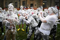 <p>Students from St Andrews University indulge in a tradition of covering themselves with foam to honor the “academic family” on Lower College Lawn on Oct. 23, 2017, in St Andrews, Scotland. (Photo: Jeff J Mitchell/Getty Images) </p>