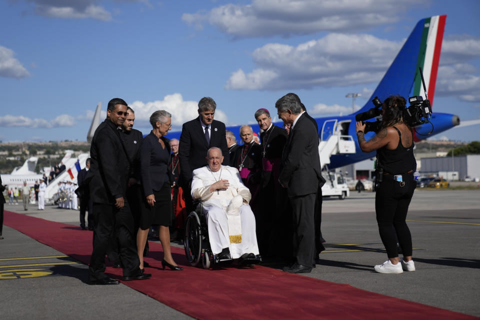 Pope Francis is welcomed by French Prime Minister Elisabeth Borne, third from left, as he arrives at Marseille International Airport in Marseille, southern France for a two-day visit, Friday, Sept. 22, 2023, where he will join Catholic bishops from the Mediterranean region on discussions that will largely focus on migration. (AP Photo/Alessandra Tarantino)