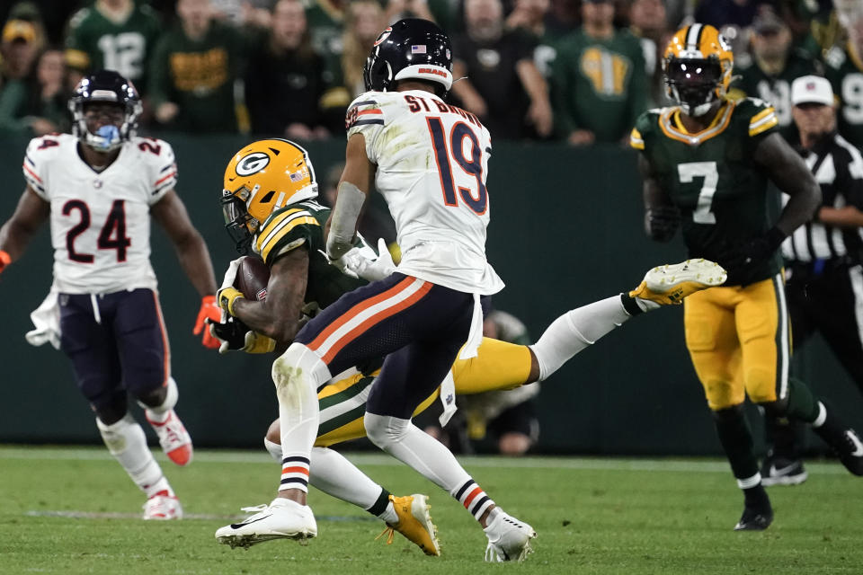 Green Bay Packers cornerback Jaire Alexander intercepts a pass ahead of Chicago Bears wide receiver Equanimeous St. Brown (19) during the second half of an NFL football game Sunday, Sept. 18, 2022, in Green Bay, Wis. (AP Photo/Morry Gash)