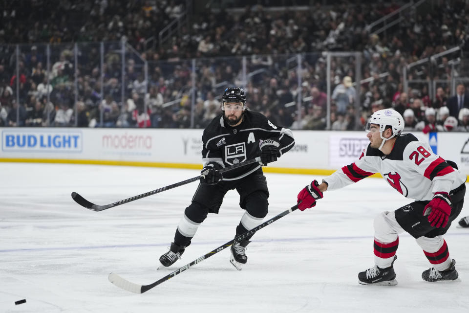 Los Angeles Kings defenseman Drew Doughty, left, clears the puck past New Jersey Devils right wing Timo Meier during the second period of an NHL hockey game, Sunday, March 3, 2024, in Los Angeles. (AP Photo/Ryan Sun)