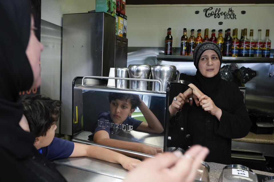 Tatiana Alabsi, left to right, and her son Sami visit with Iman Diab, who owns a cafe, in the Tenderloin neighborhood Saturday, April 20, 2024, in San Francisco. (AP Photo/Godofredo A. Vásquez)