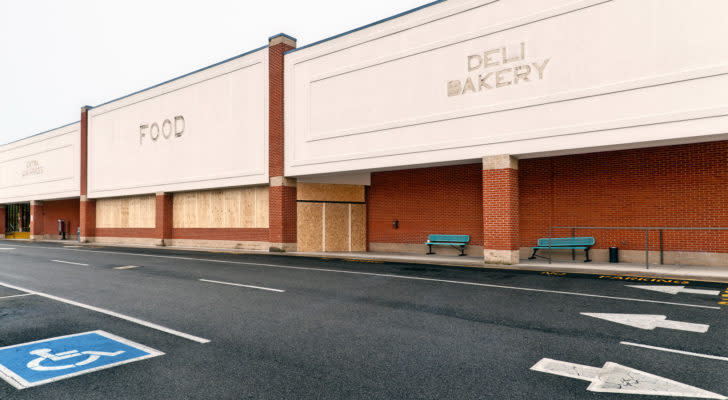 Large supermarket in a shopping center abandoned and boarded up