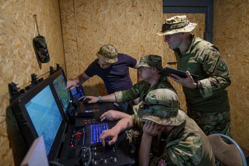 Ukrainian servicemen of the Ochi reconnaissance unit operate a Furia drone during a flight over Russian positions at the frontline in Donetsk region (AP)