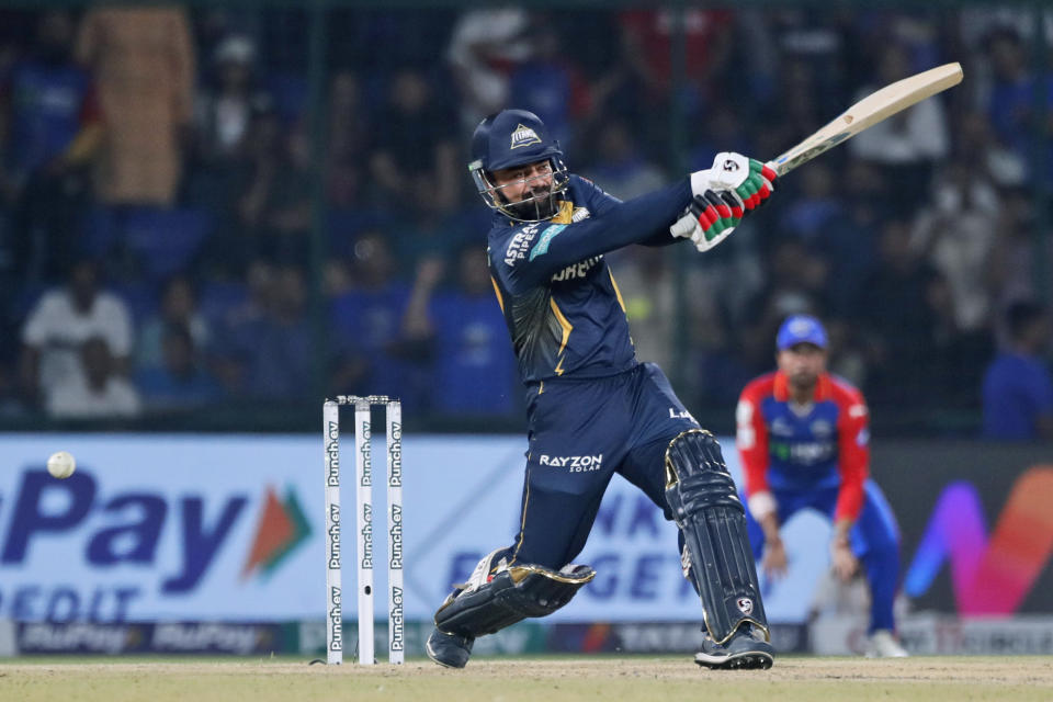 Gujarat Titans' Rashid Khan plays a shot during the Indian Premier League cricket match between Delhi Capitals and Gujarat Titans in New Delhi, India, Wednesday, April 24, 2024. (AP Photo/Pankaj Nangia)