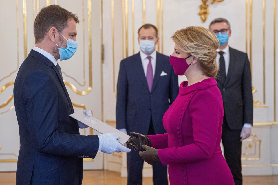 Newly appointed Slovak Prime Minister Igor Matovic (L), leader of the OLaNO anti-graft party and President Zuzana Caputova take part in a swearing in ceremony of the new four-party coalition government on March 21, 2020 at the Presidential palace in Bratislava. - The ceremony was held without members of the press and all appointed government members wore gloves and face mask to prevent the spread of novel coronavirus. (Photo by Michal SVITOK / POOL / AFP) (Photo by MICHAL SVITOK/POOL/AFP via Getty Images)