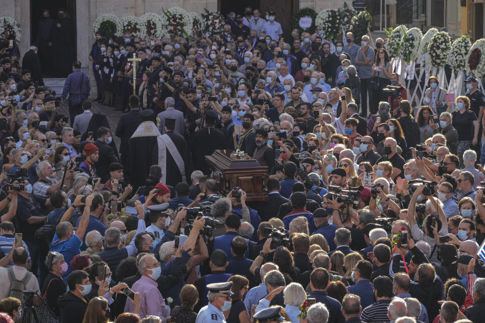 Pallbearers carry the coffin of late Greek composer, Mikis Theodorakis outside the Metropolitan church, prior to his funeral service, in Chania, Crete island, Greece, Thursday, Sept. 9 2021. Theodorakis died Thursday, Sept. 2, 2021 at 96. He penned a wide range of work, from somber symphonies to popular TV and film scores, including for “Serpico” and “Zorba the Greek.” He is also remembered for his opposition to the military junta that ruled Greece from 1967-1974, when he was persecuted and jailed and his music outlawed. (AP Photo/Harry Nakos)